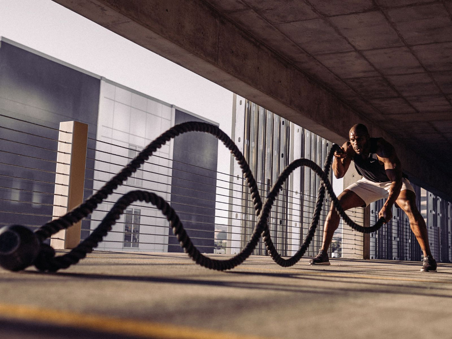 Man working out with ropes in the gym