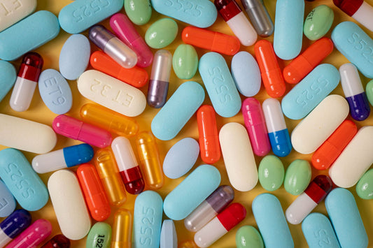 An assortment of brightly coloured supplement capsules arranged on a flat surface