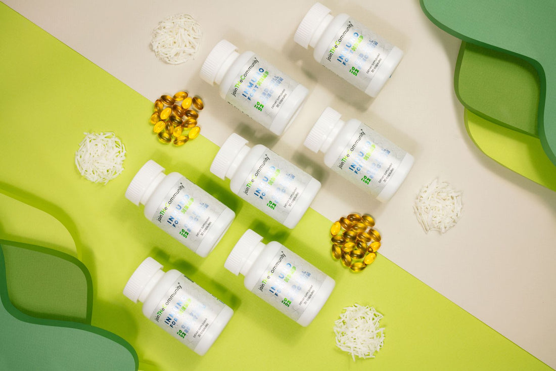 Supplement bottles and vials arranged in a flat lay on a green background