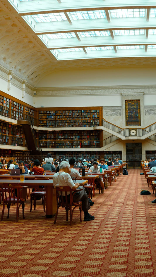 The reading room of a historic library lined with bookshelves