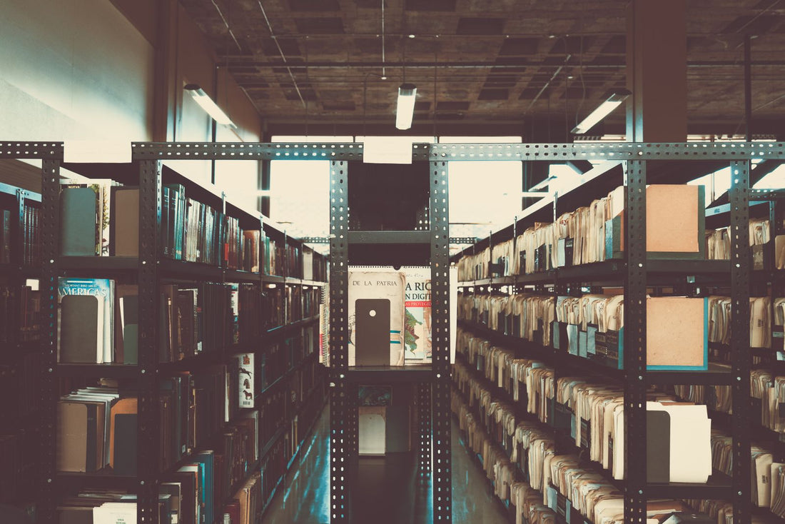 A long corridor of bookshelves in an old library
