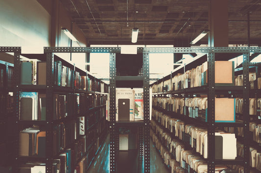 A long corridor of bookshelves in an old library