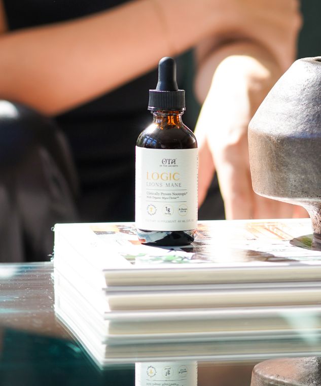 Logic Lion's Mane tincture bottle in warm natural light.